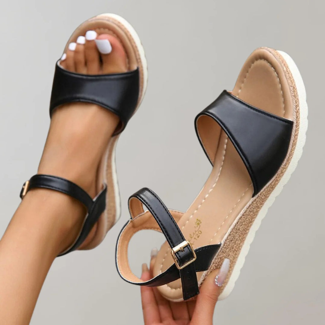 Wedge sandals with an open toe and adjustable strap